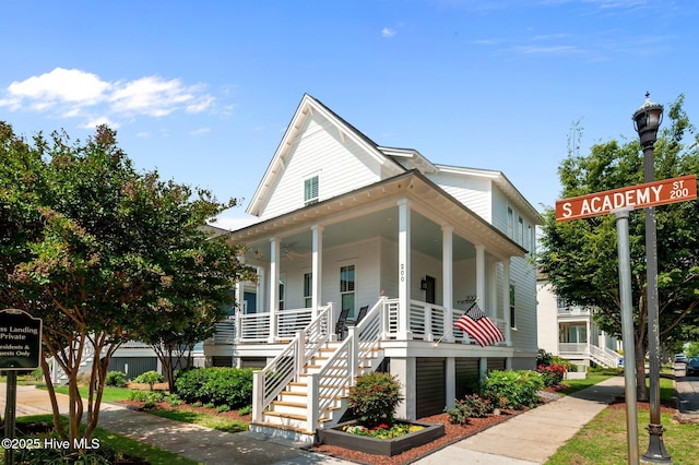view of front of property featuring stairway and covered porch