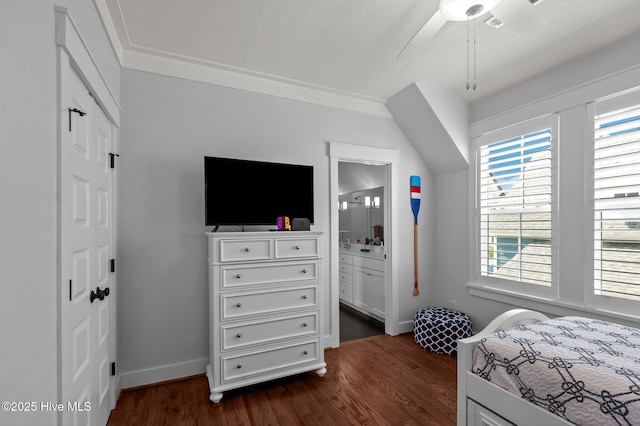 bedroom featuring dark wood finished floors, baseboards, a closet, ensuite bath, and ceiling fan