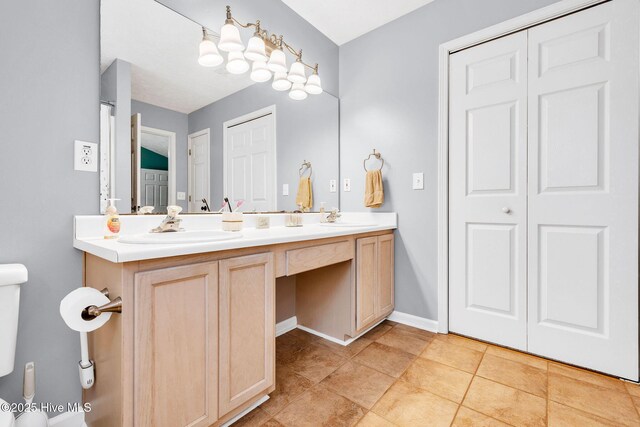 7394 Red Stone Ct, Leland, NC 28451 - full bath with double vanity, toilet, a closet, tile patterned floors, and baseboards