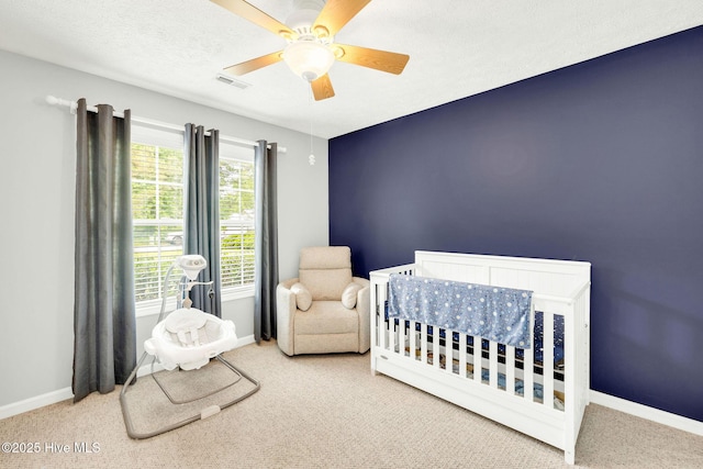 7394 Red Stone Ct, Leland, NC 28451 - carpeted bedroom featuring baseboards, ceiling fan, and a crib