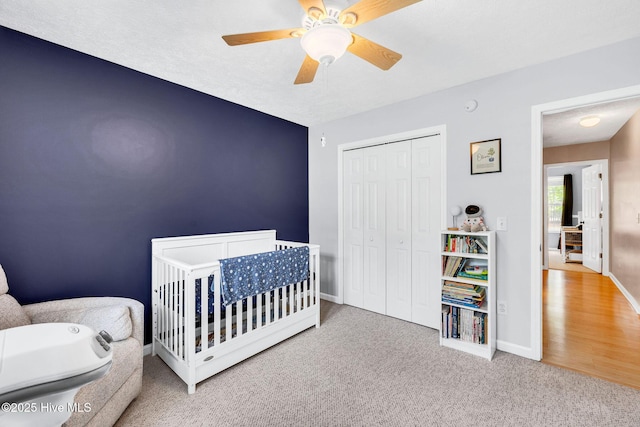 7394 Red Stone Ct, Leland, NC 28451 - carpeted bedroom featuring baseboards, a closet, a crib, and ceiling fan