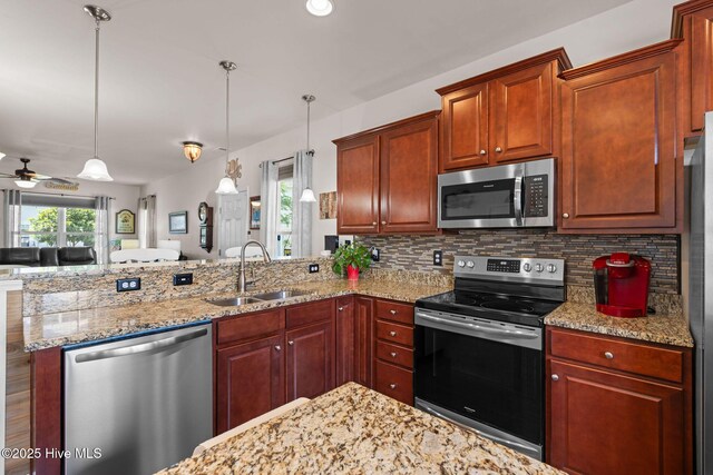 4007 Norseman Loop Unit 5, Southport, NC 28461 - kitchen featuring stainless steel appliances, a sink, a peninsula, decorative backsplash, and ceiling fan