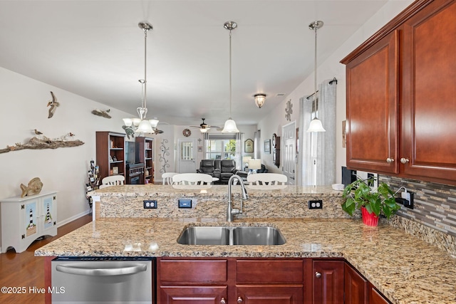4007 Norseman Loop Unit 5, Southport, NC 28461 - kitchen featuring stainless steel dishwasher, a sink, wood finished floors, a peninsula, and tasteful backsplash