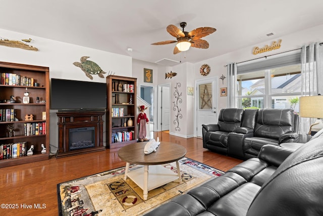 4007 Norseman Loop Unit 5, Southport, NC 28461 - living room with wood finished floors, a glass covered fireplace, and a ceiling fan