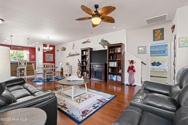 4007 Norseman Loop Unit 5, Southport, NC 28461 - living area with a ceiling fan, baseboards, wood finished floors, and a chandelier