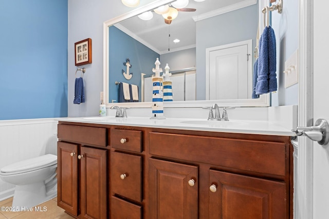 4007 Norseman Loop Unit 5, Southport, NC 28461 - full bath with ornamental molding, double vanity, a shower with shower door, a wainscoted wall, and toilet