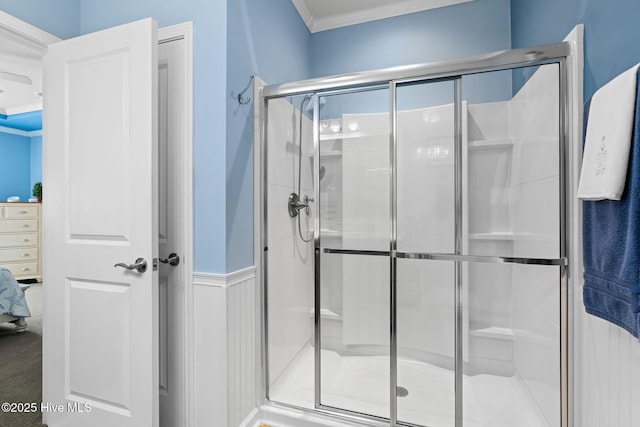 4007 Norseman Loop Unit 5, Southport, NC 28461 - bathroom featuring ornamental molding, a stall shower, and wainscoting