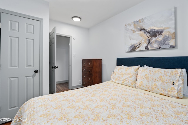 bedroom featuring wood finished floors and baseboards