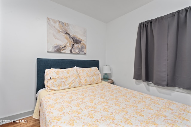 bedroom with wood finished floors