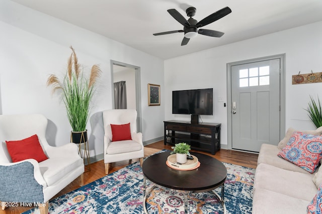 living area with wood finished floors and ceiling fan