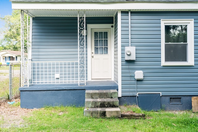view of exterior entry with fence