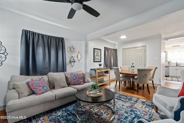 living area featuring wood finished floors and a ceiling fan