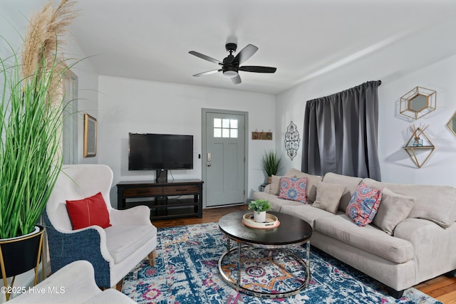 living room with ceiling fan and wood finished floors