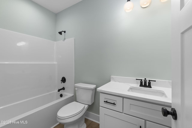 full bath featuring toilet, vanity, baseboards,  shower combination, and wood finished floors