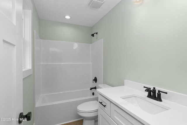 bathroom with toilet, vanity, and bathtub / shower combination