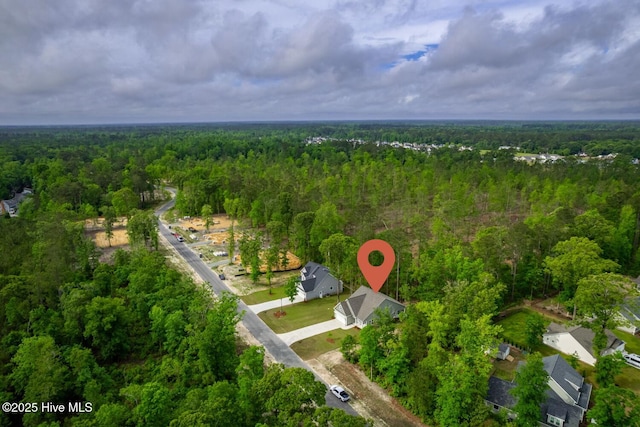 aerial view of property's location with a forest