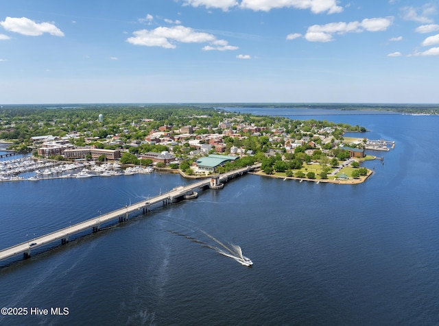 drone / aerial view of a nearby body of water and a notable bridge