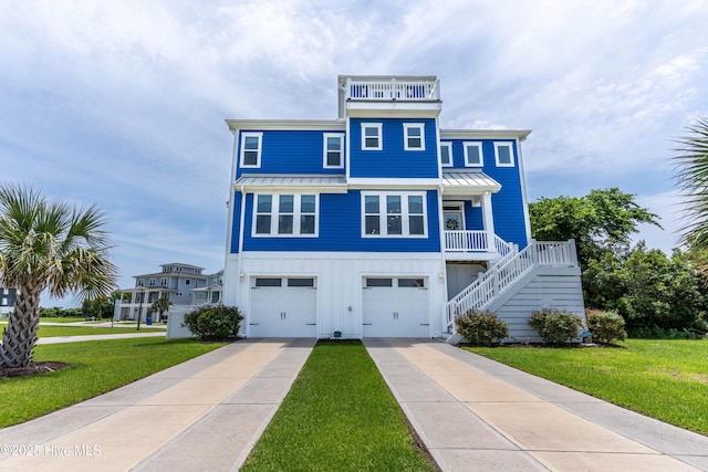 145 Whispering Pine Ln, Holly Ridge, NC 28445 - beach home featuring a standing seam roof, board and batten siding, an attached garage, and a front yard