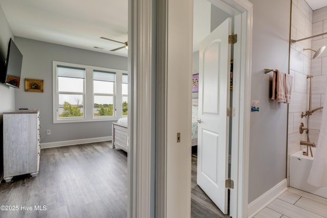 145 Whispering Pine Ln, Holly Ridge, NC 28445 - full bath featuring ceiling fan, shower / tub combination, wood finished floors, and baseboards