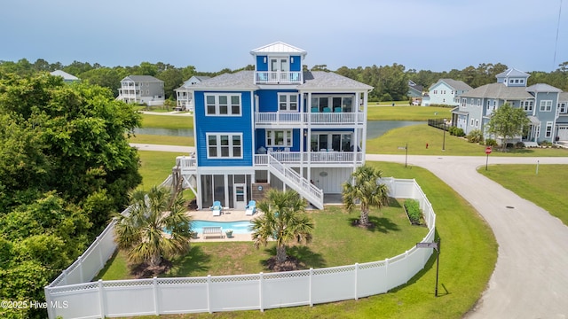 145 Whispering Pine Ln, Holly Ridge, NC 28445 - rear view of property with a balcony, stairs, a water view, a patio, and a residential view