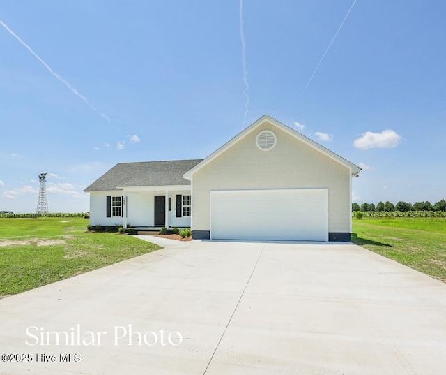 128 Buckskin Dr, Pollocksville, NC 28573 - view of front of house with a front yard, a porch, a garage, and driveway