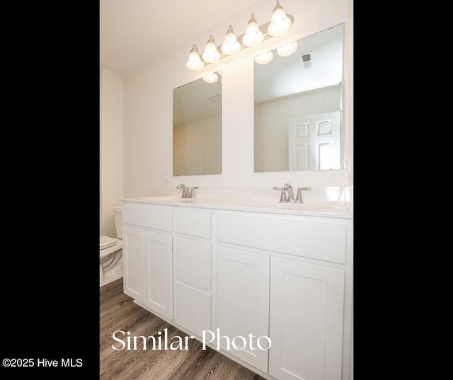 128 Buckskin Dr, Pollocksville, NC 28573 - bathroom featuring double vanity and wood finished floors