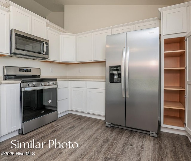 128 Buckskin Dr, Pollocksville, NC 28573 - kitchen with appliances with stainless steel finishes, dark wood finished floors, white cabinetry, and vaulted ceiling