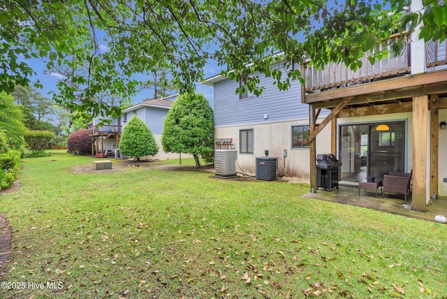 view of grassy yard with central AC