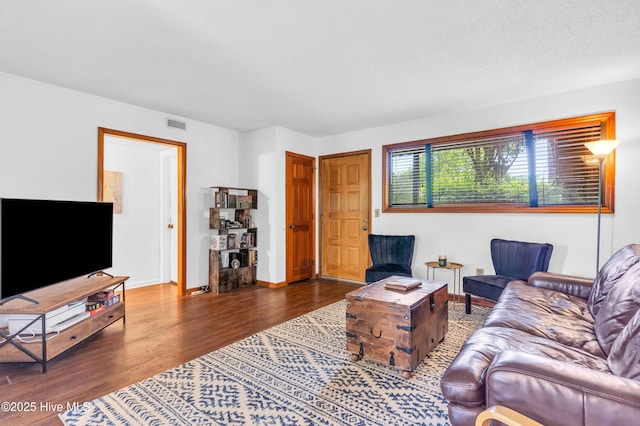 living area with wood finished floors and baseboards
