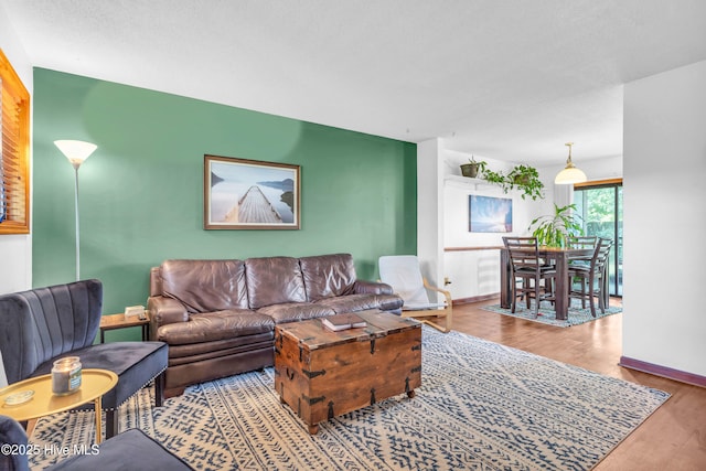 living room featuring wood finished floors and baseboards