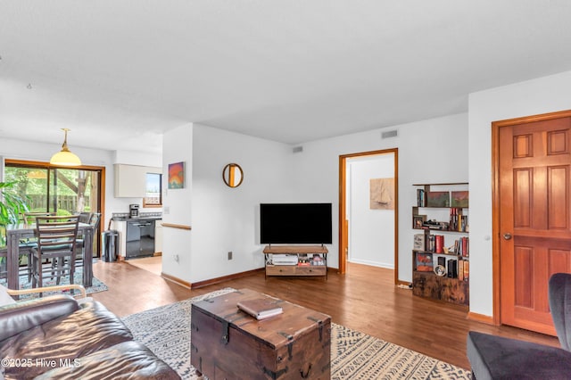 living room with wood finished floors and baseboards