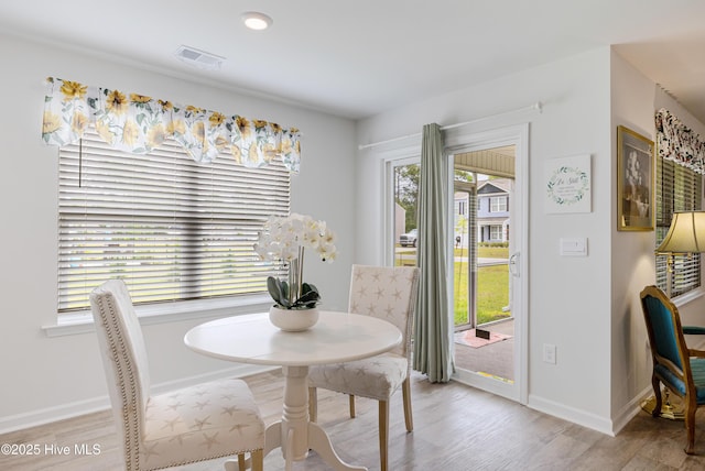 dining area featuring wood finished floors and baseboards