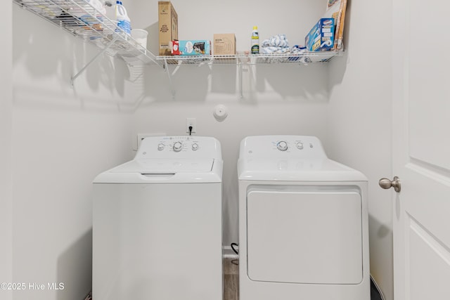 clothes washing area featuring washer and clothes dryer