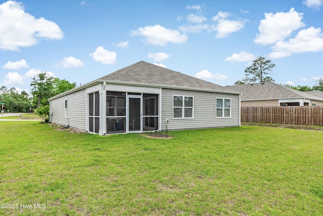 rear view of house with a sunroom and roof with shingles