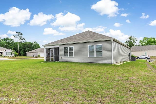 rear view of house featuring a yard, cooling unit, roof with shingles, and a sunroom