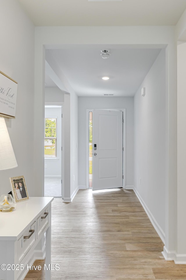 entrance foyer featuring baseboards and light wood finished floors