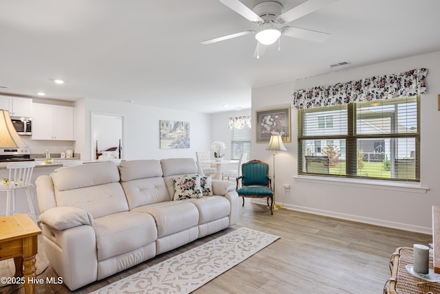 living room with ceiling fan, light wood-type flooring, baseboards, and recessed lighting