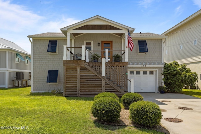 141 Bayview Blvd, Atlantic Beach, NC 28512 - view of front of property with a garage, stairway, driveway, a front yard, and covered porch