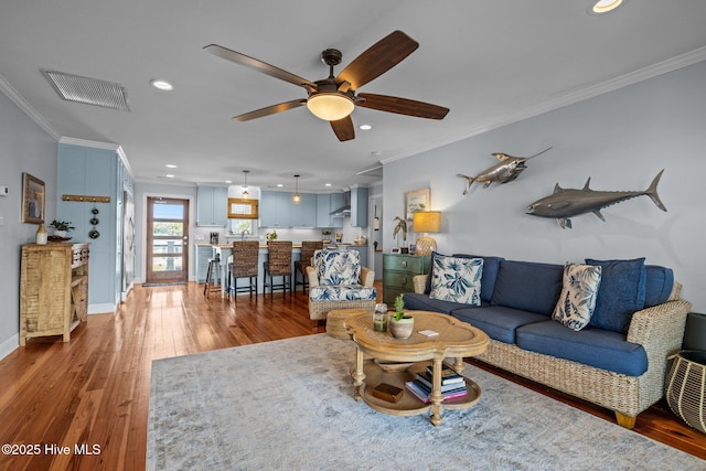 141 Bayview Blvd, Atlantic Beach, NC 28512 - living area with crown molding, light wood-style flooring, recessed lighting, ceiling fan, and baseboards