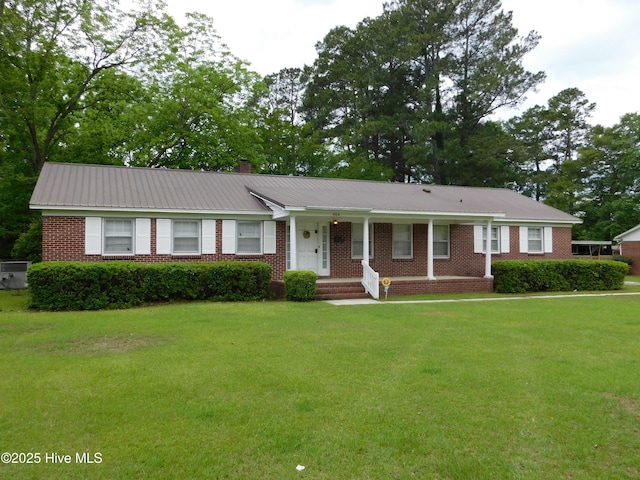 404 N Marlboro St, Mccoll, SC 29570 - ranch-style home featuring a front yard, brick siding, a chimney, and metal roof