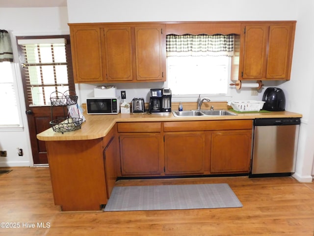 404 N Marlboro St, Mccoll, SC 29570 - kitchen with dishwasher, a sink, light countertops, brown cabinets, and light wood-style floors
