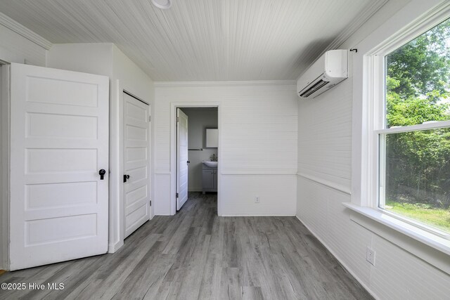 808 Green St, New Bern, NC 28560 - unfurnished room with a wall mounted AC, healthy amount of natural light, wood finished floors, ornamental molding, and a sink