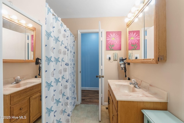full bathroom with two vanities, a shower with curtain, and tile patterned floors