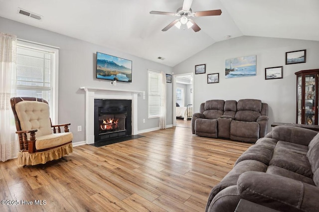 312 Hughes Ln, Jacksonville, NC 28546 - living room with light wood-style flooring, a ceiling fan, lofted ceiling, a fireplace with flush hearth, and baseboards