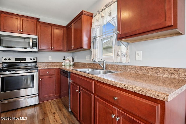 312 Hughes Ln, Jacksonville, NC 28546 - kitchen with appliances with stainless steel finishes, a sink, dark wood finished floors, and light countertops