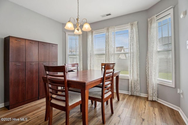 312 Hughes Ln, Jacksonville, NC 28546 - dining room with light wood-style floors, a chandelier, and baseboards