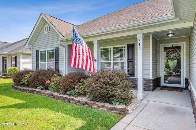 312 Hughes Ln, Jacksonville, NC 28546 - view of side of home with a shingled roof, a yard, and covered porch