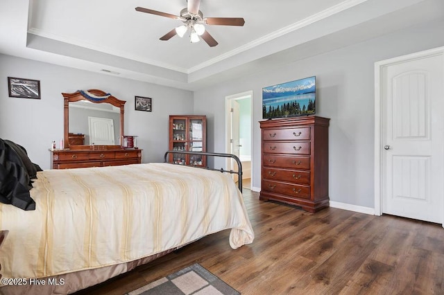 312 Hughes Ln, Jacksonville, NC 28546 - bedroom featuring dark wood-type flooring, a raised ceiling, crown molding, baseboards, and a ceiling fan