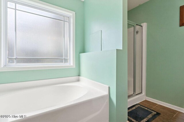 312 Hughes Ln, Jacksonville, NC 28546 - bathroom featuring a shower stall, a garden tub, tile patterned floors, and plenty of natural light