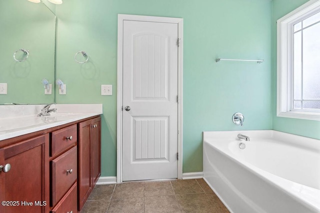 312 Hughes Ln, Jacksonville, NC 28546 - bathroom with vanity, baseboards, a garden tub, and tile patterned flooring